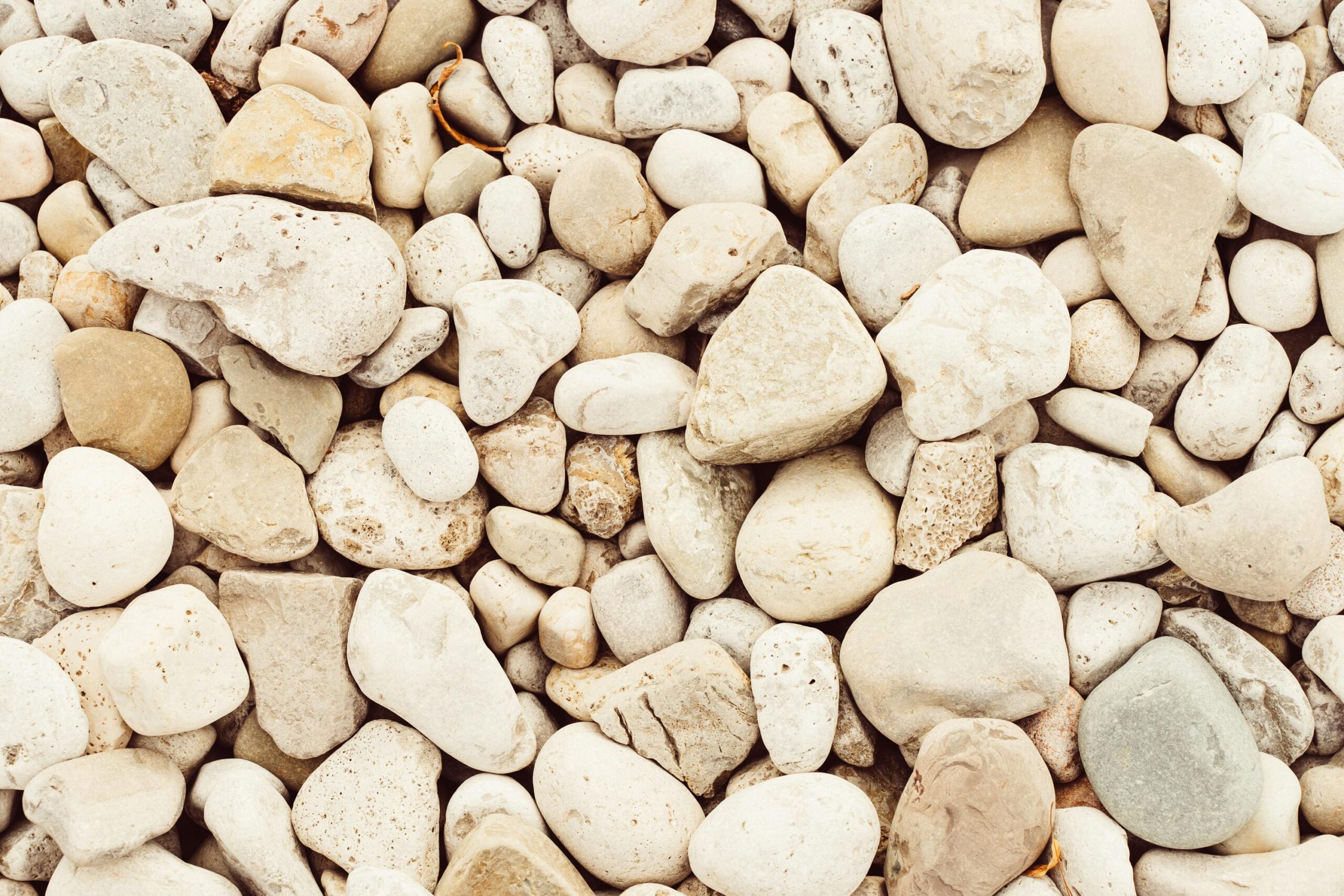 Smooth stones forming a natural texture background in neutral colors found in Oakville, Canada.